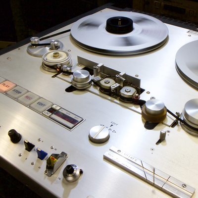 Reel-to-reel rape machine with tape spinning and play button lit up