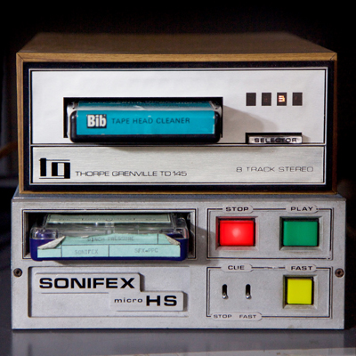 1970s-style brushed steel box with large red (stop), green (play) and yellow (fast) buttons, and Sonifex pinch pressure gauge cartridge inserted