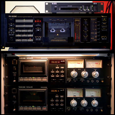 Stack of 3 Audio Cassette Decks with multiple buttons and level indicators: one Nakamichi 505E and two Tascam 122 MkIII machines. A smaller box labelled Lavry AD10