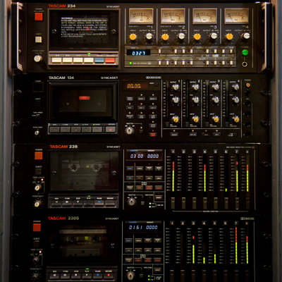 enlarged image shows stack of 4 rack-based Audio Cassette Decks with multiple buttons and level indicators