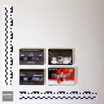 4 rectangular plastic 8mm video cassettes with rulers indicating width 9.4 cm by height 6.1 cm