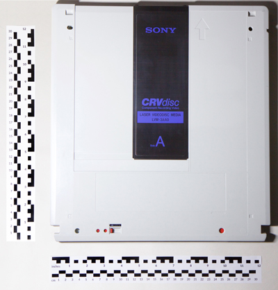 CRVdisc resembling outlandishly large floppy disc, with rulers indicating width 32.5cm by height 34.4 cm