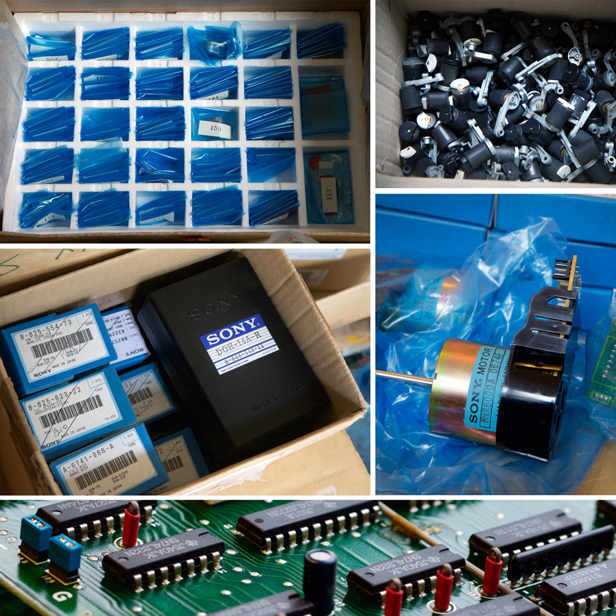 tray of small parts in blue plastic; open box of pinch arms; Sony betacam motors; close up of Sony BVH 2000PS motherboard; open box of smaller blue and black Sony boxes